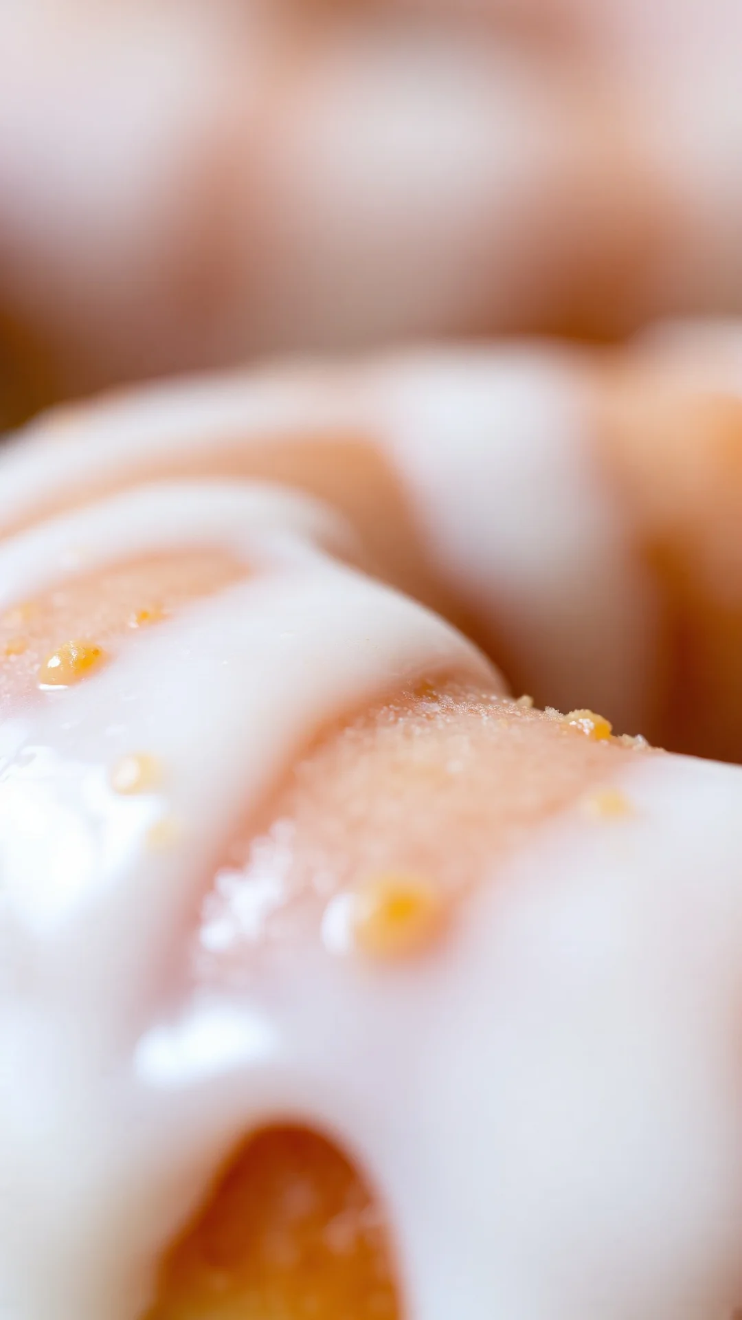 Close-up of glazed donut with thick white icing dripping, golden fried texture, creamy frosting detail, bokeh background, mac